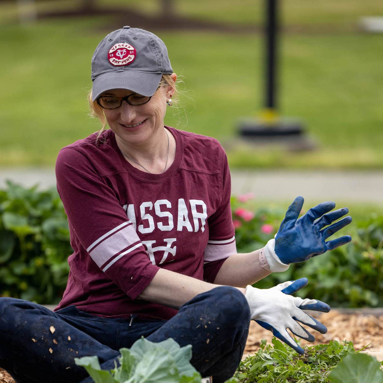 Volunteer in a Vassar Jersey planting flowers
